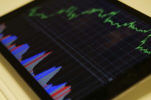 Tablet exibindo gráficos coloridos representando o crescimento financeiro e análise de investimentos.